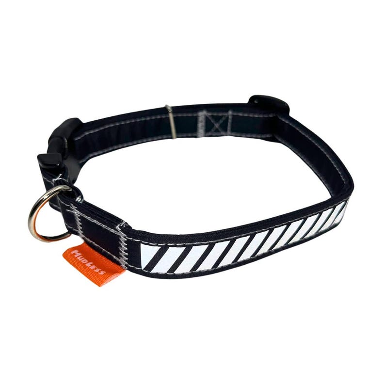 May include: Black dog collar with a white reflective stripe pattern and a small orange tag that says "Muddy Paws".