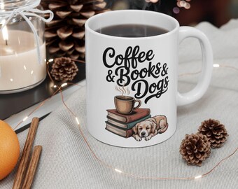 May include: White ceramic mug with the text "Coffee & Books & Dogs" in black script. The mug features a graphic of a coffee cup, books, and a dog. The mug is filled with a dark liquid and has a white handle.