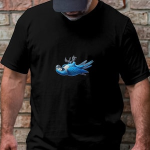 May include: A black t-shirt featuring a printed blue and green parrot on the front. The parrot is upside down with its wings outstretched.