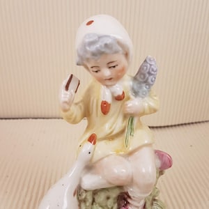 Vintage porcelain girl with goose figurine Germany antique with micro chip on flower