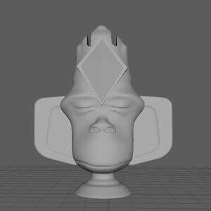 May include: A gray ceramic trophy with a diamond-shaped design on the top. The trophy is sitting on a gray base.