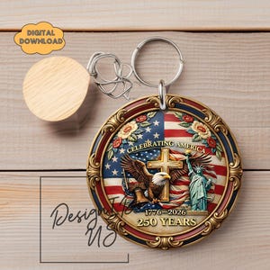 May include: A round keychain with a patriotic design. The keychain features an American flag, an eagle, the Statue of Liberty, and the text "Celebrating America 1776-2026 250 Years." The keychain has a gold-colored border and a silver keyring.
