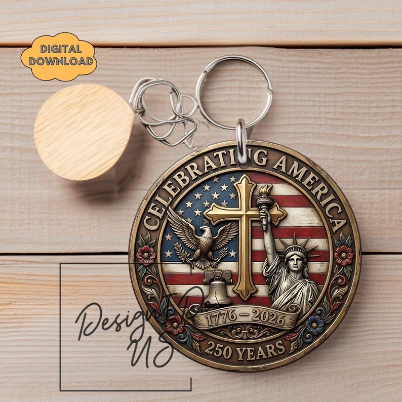 May include: A round metal keychain with the words "Celebrating America" and the years "1776-2026". The design includes an American flag, an eagle, a cross, the Statue of Liberty, and a bell. A wooden disc is attached to the keychain.