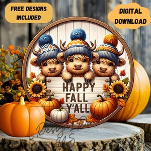 May include: A round wooden sign with three Highland cows wearing hats and holding a sign that says "Happy Fall Y'all". The sign is surrounded by sunflowers and pumpkins.