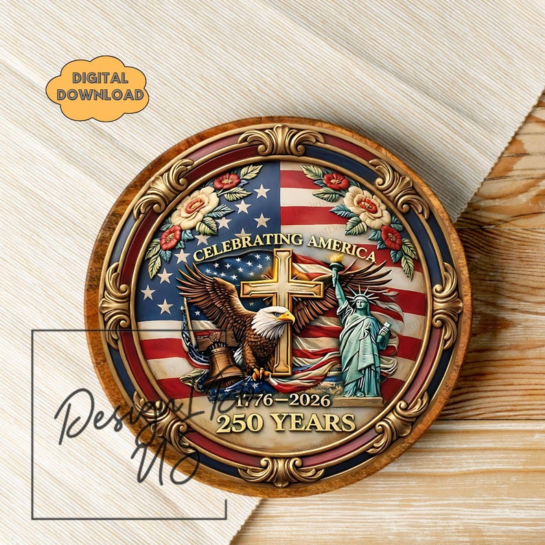 May include: A round wooden plaque with a patriotic design. The plaque features the American flag, an eagle, the Statue of Liberty, and the text "Celebrating America 1776-2026 250 Years." The design is framed with gold accents and floral elements.