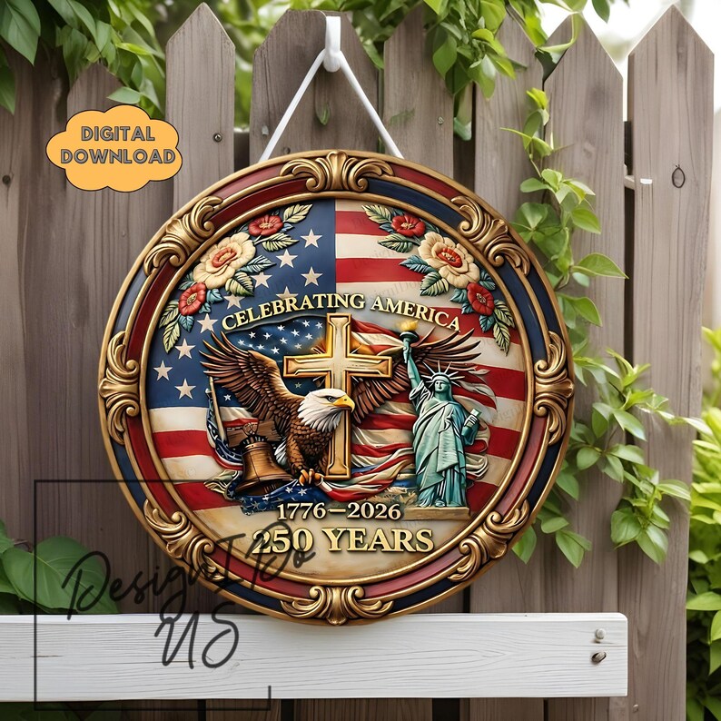May include: A round wooden sign with a patriotic theme. The sign features the American flag, an eagle, the Statue of Liberty, and the text "Celebrating America 1776-2026 250 Years." The sign has a decorative gold border and is hanging on a wooden fence.