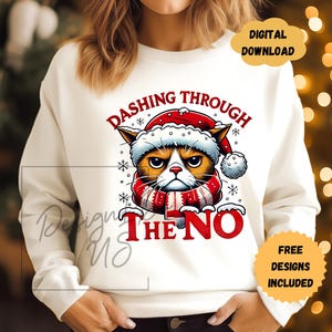 May include: White sweatshirt with a grumpy cat wearing a Santa hat and scarf. The text "Dashing Through The No" is printed on the sweatshirt.
