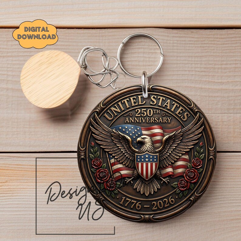May include: A bronze-coloured keychain featuring an eagle with outstretched wings, the American flag, and roses. The text "UNITED STATES 250TH ANNIVERSARY 1776-2026" is displayed. A wooden disc and a metal keyring are also visible.