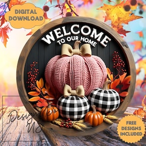 May include: A circular wooden sign with the text "WELCOME TO OUR HOME". It features a pink knitted pumpkin, two black and white checkered pumpkins, and two orange pumpkins. The sign also includes the text "DIGITAL DOWNLOAD" and "FREE DESIGNS INCLUDED".