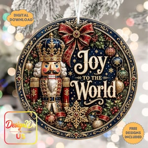 May include: A round Christmas ornament featuring a nutcracker in a blue and red uniform with a gold crown. The text reads Joy TO THE WORLD. The design includes a large red bow, holly, snowflakes, and hanging baubles on a dark blue background.