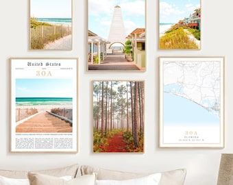 May include: A set of six framed prints featuring beach scenes and a map of 30A, Florida. The prints include a beach with a wooden walkway, a white building with a tall spire, a beach with a wooden fence, a forest path, and a map of the 30A area. The prints are all in a light wood frame.