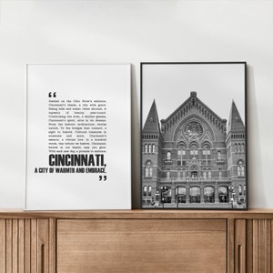 May include: Black and white photo of a building with a quote about Cincinnati, Ohio. The quote reads, "Nestled on the Ohio River's embrace, Cincinnati's charm, a city with grace. Rising hills and scenic views abound, A tapestry of beauty, year-round. Overlooking the river, a skyline gleams, Cincinnati's spirit, alive in its dreams. From the historic architecture, stories untold, To the bridges that connect, a sight to behold. Cultural treasures in museums and more, Cincinnati's essence, a vibrant lore. In a hundred words, this tribute we bestow, Cincinnati, forever in our hearts, may you glow. With each new day, a promise to embrace, CINCINNATI, A CITY OF WARMTH AND EMBRACE."