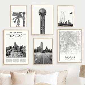 May include: A collection of framed black and white prints featuring Dallas, Texas landmarks. The prints include images of the Dallas skyline, a map, and iconic structures like the Reunion Tower and the Margaret Hunt Hill Bridge.