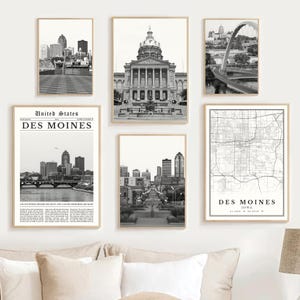 May include: A collection of six framed black and white prints featuring Des Moines, Iowa. The prints include cityscapes, architectural landmarks, and a map of the city. The frames are a light wood color.