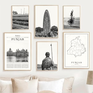 May include: A collection of framed black and white prints featuring scenes from Punjab, India. The images include landscapes, architecture, and historical figures. The prints are displayed on a white wall above a cream-colored sofa.