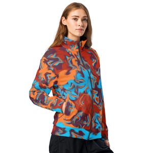 May include: A colorful jacket with a blue, orange, and red abstract swirl pattern. The jacket has a zipper closure and a stand-up collar.