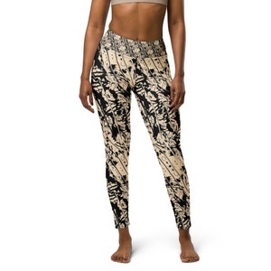 May include: Black and beige patterned leggings with a high waist. The leggings have a geometric design with black and beige stripes and circles.