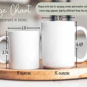 May include: Two white ceramic mugs with black text and measurements in inches. The mug on the left is 11 ounces and the mug on the right is 15 ounces.
