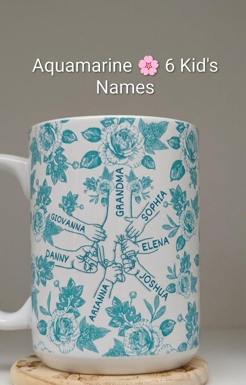 May include: White ceramic mug with a teal floral pattern and the words "Aquamarine 6 Kid's Names." The mug features six names: Giovanna, Danny, Arianna, Joshua, Elena, and Sophia. The mug has a white handle.