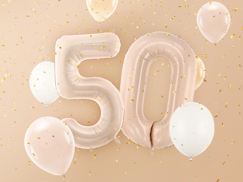 Large beige number balloons forming 50, neutral milestone decoration for a 50th birthday party