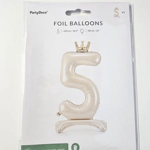 May include: A white foil balloon shaped like the number 5 with a gold crown on top. The balloon is 40.5 inches tall and 33 inches wide. The packaging says "FOIL BALLOONS" and "You can use me again, don't throw me out, please."