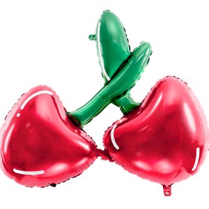 A foil balloon shaped like two glossy red cherries with green stems, joined together as a single piece. The cherries have a shiny surface. Set against a white background.