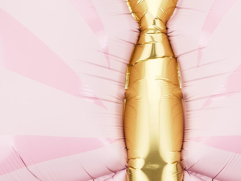 May include: A gold foil balloon shaped like a butterfly with pink wings.