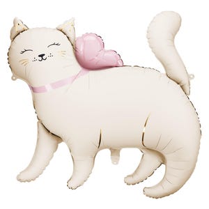 Cream-colored foil balloon shaped like a smiling cat with golden whiskers, pink ribbon around its neck, and a pink heart-shaped balloon on its back. The cat is standing with its tail curled upward, appearing cheerful and playful.