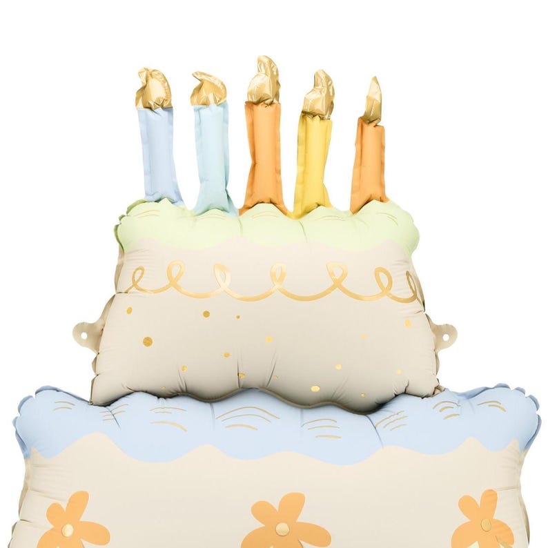 May include: A large, multi-layered cake balloon with pastel blue, yellow, and green frosting. The cake has five candles on top, each with a gold flame. The candles are in shades of orange, yellow, and blue.