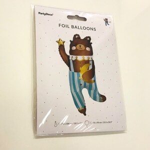 A brown bear foil balloon holding a gold star and a gold crescent moon. The balloon is wearing blue and white striped pyjamas. The balloon is 72 cm by 104 cm.