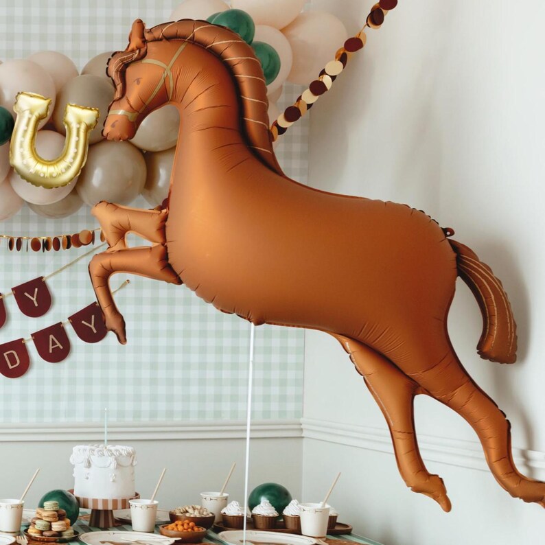 Large brown galloping horse balloon displayed as western party and horse birthday decoration