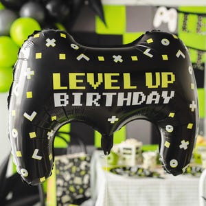 Level Up Birthday game controller foil balloon, black gaming party decoration with neon green and white details