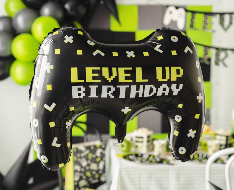 Level Up Birthday game controller foil balloon, black gaming party decoration with neon green and white details