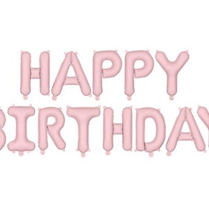 May include: Happy Birthday banner made of pink foil balloons. The balloons are inflated and spell out "Happy Birthday".