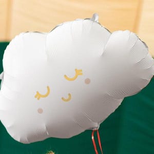 White cloud foil balloon with sleepy gold and pink face, styled for baby shower and nursery themed party decor
