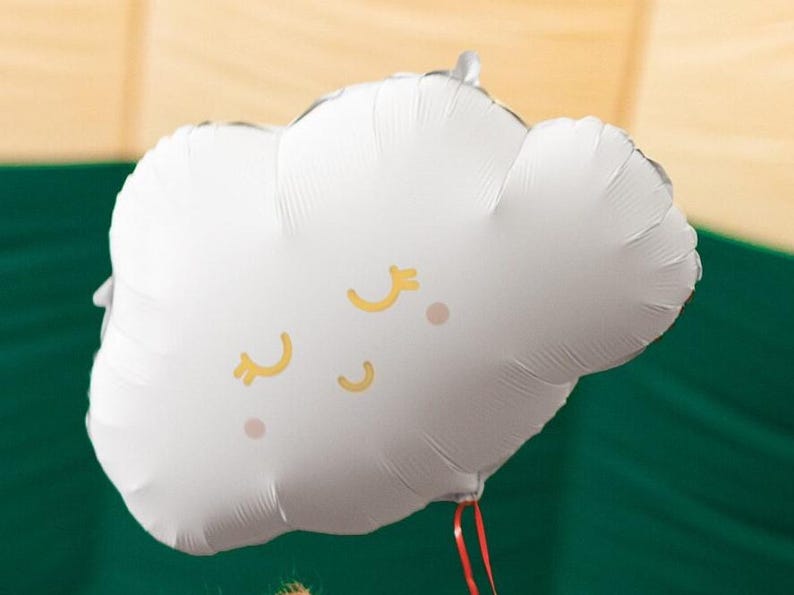 White cloud foil balloon with sleepy gold and pink face, styled for baby shower and nursery themed party decor