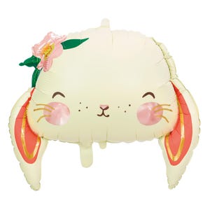 May include: A white balloon shaped like a bunny with pink cheeks, a small brown nose, and a green flower on its head. The bunny's ears are red with gold trim.
