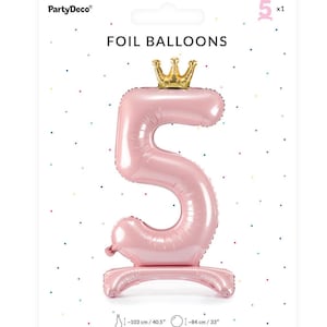 May include: Pink foil balloon shaped like the number 5 with a gold crown on top. The balloon is 40.5 inches tall and 33 inches wide.