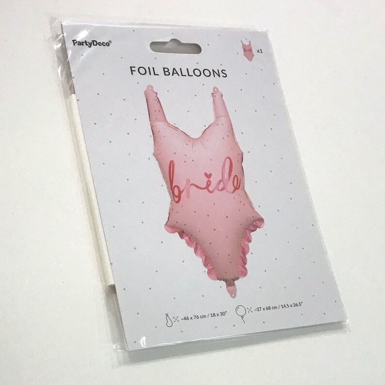 May include: Pink foil balloon shaped like a swimsuit with the word "bride" in pink lettering and a small heart. The balloon is 18 inches by 30 inches.