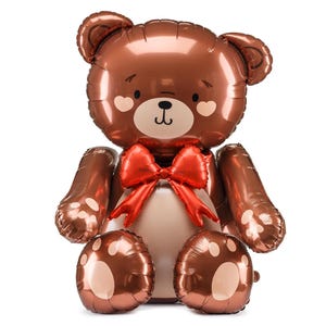 A shiny, metallic brown teddy bear balloon with a cute, smiling face, heart-shaped blush marks on its cheeks, and a large red bow around its neck. The bear is seated with its arms and legs extended, featuring paw print designs on its feet.