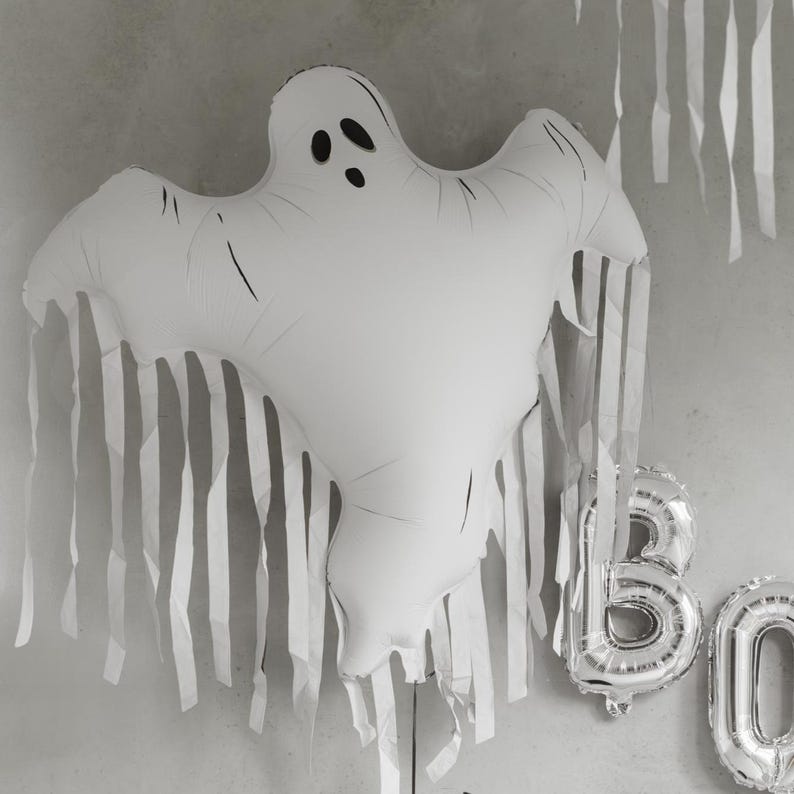 Large ghost balloon with long hanging tassels creating a floating Halloween decoration