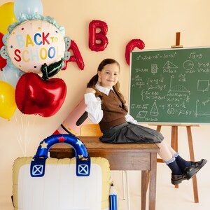 Red apple foil balloon decorating a classroom for back to school celebration with kids