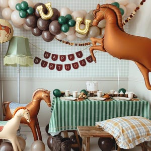Galloping horse foil balloon with western party table decor for cowboy or horse themed celebration
