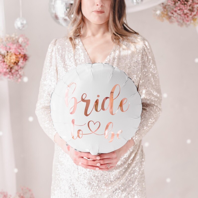 May include: White balloon with the text "bride to be" in rose gold lettering.