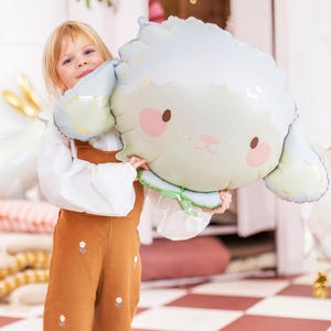 Cute sheep foil balloon styled for a child's birthday party, pastel lamb decoration for a sweet animal themed celebration