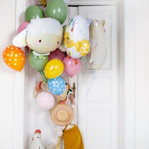 Cute sheep balloon displayed with colorful party balloons, playful animal decoration for kids birthday or farm themed party