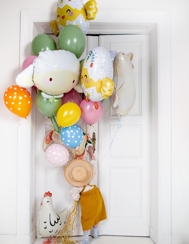 Cute sheep balloon displayed with colorful party balloons, playful animal decoration for kids birthday or farm themed party