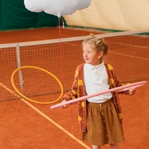 White cloud balloon displayed with warm neutral party decorations for baby shower, newborn or first birthday