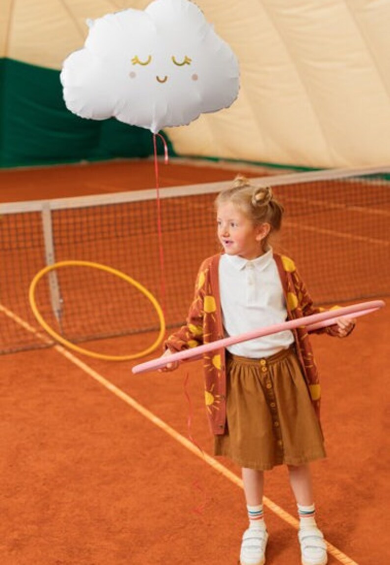 White cloud balloon displayed with warm neutral party decorations for baby shower, newborn or first birthday