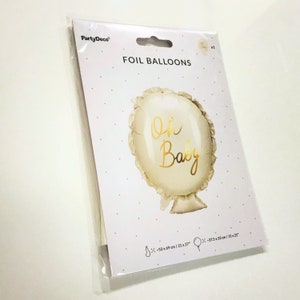 May include: A white foil balloon with a gold 'Oh Baby' inscription. The balloon is 21 inches by 27 inches and is packaged in a clear plastic bag.